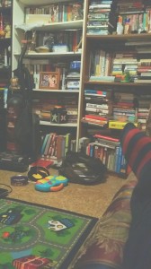Bookshelves, Shaun's toys, and a foot.
